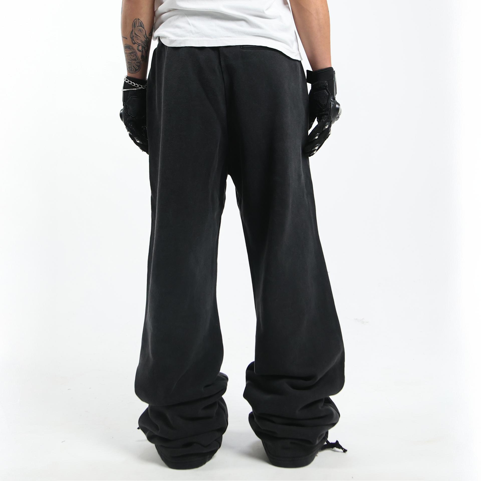 Nikolas Crow wearing Prngrphy - Wide Leg Varsity Trousers - Back - Studded Suede Boots in pink