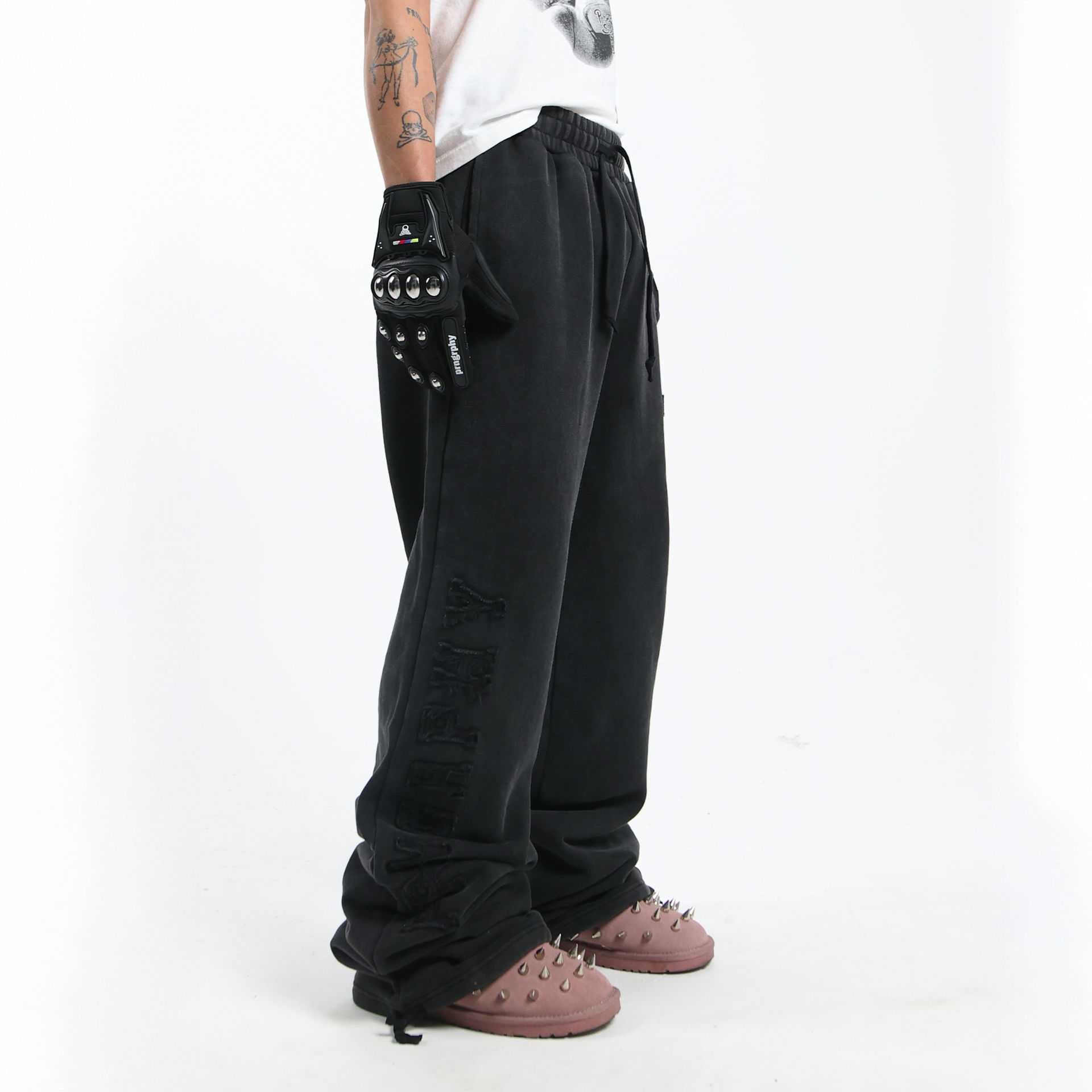 Nikolas Crow wearing Prngrphy Wide Leg Varsity Trousers SIDE Studded Suede Boots in pink