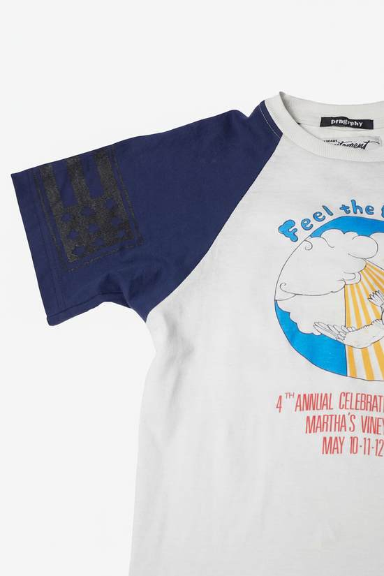 White t-shirt with blue sleeves featuring a graphic design and text on a white background